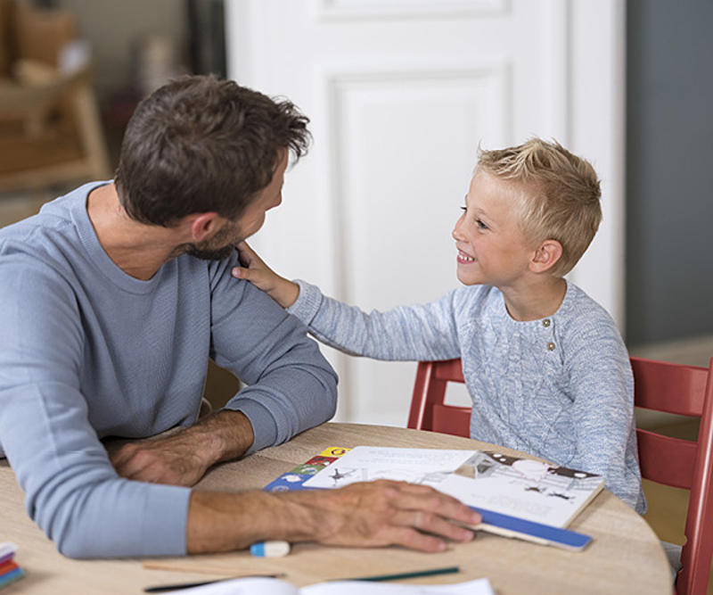 Father and son reading a book